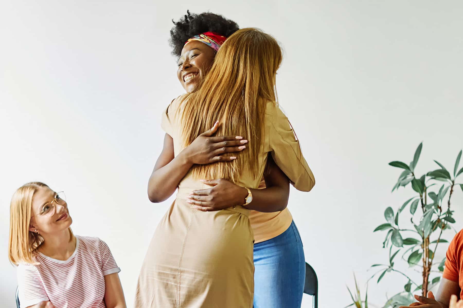 two participants in a group hugging